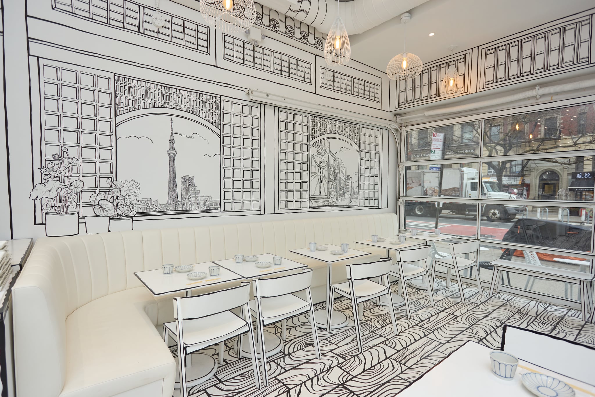 Shirokuro corner view — banquette looking onto the NYC street through illustrated-line windows