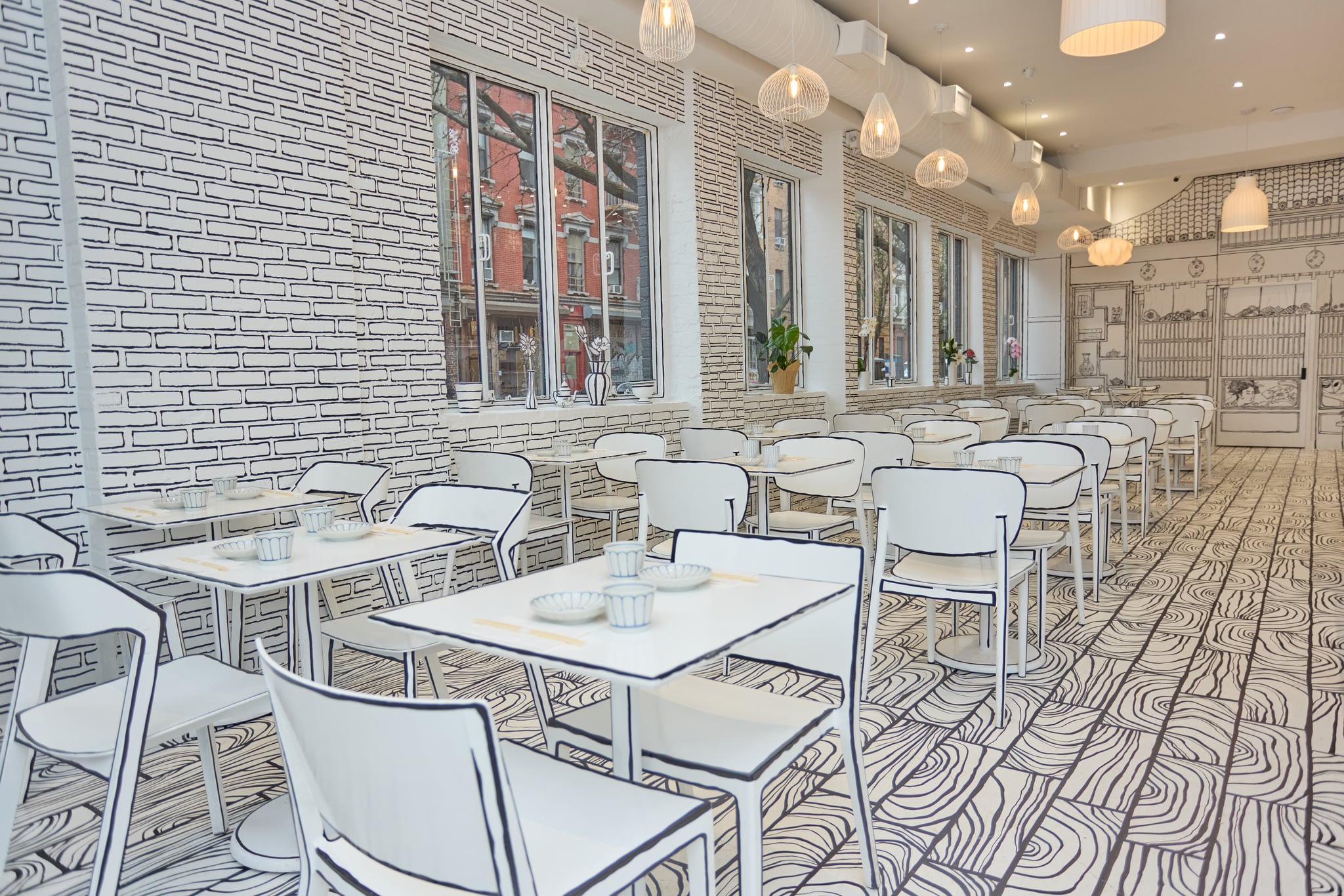Shirokuro dining room — wide view of white banquettes and illustrated-line walls